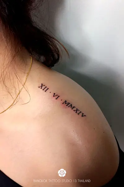 roman-numeral-date-tattoo-woman