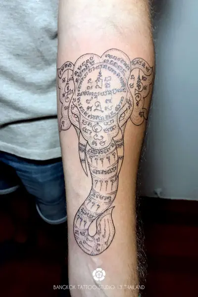 sak-yant-tattoo-face-elephant-traditional-forearm