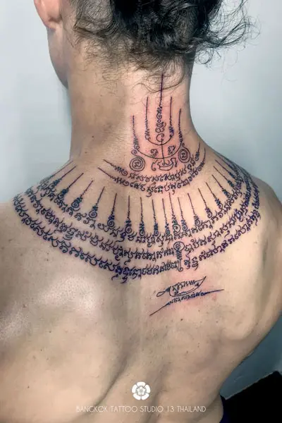 sak-yant-tattoo-on-back-and-neck-man