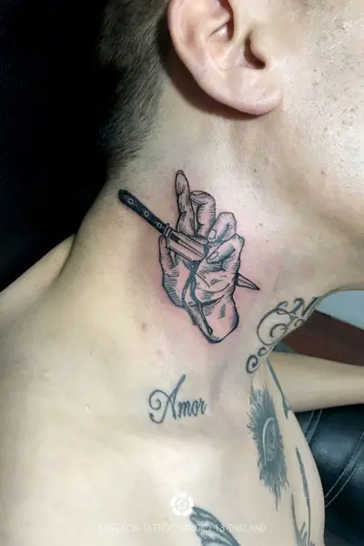 black-ink-tattoo-knife-pierces-hand