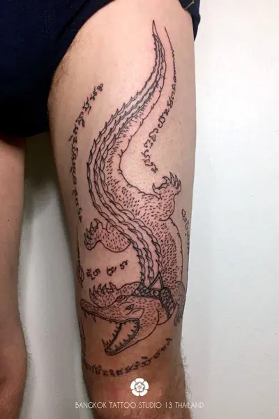 sak-yant-tattoo-crocodile-tattoo-on-thigh